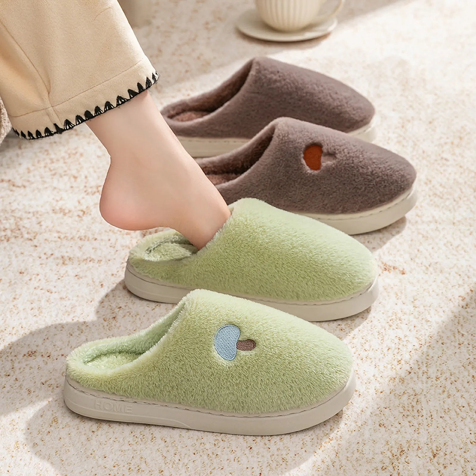 Woman wearing Green Plush Mushroom Embroidered Fleece House Slippers with Brown pair in background - RoomDen