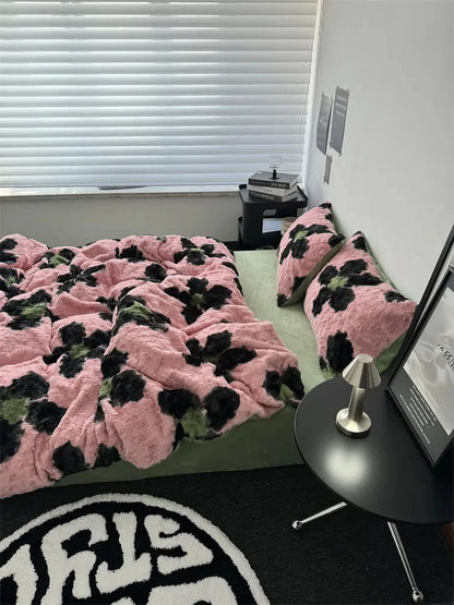 Side view of the cozy pink and black floral fleece duvet cover, showcasing its plush texture next to a black side table. - RoomDen