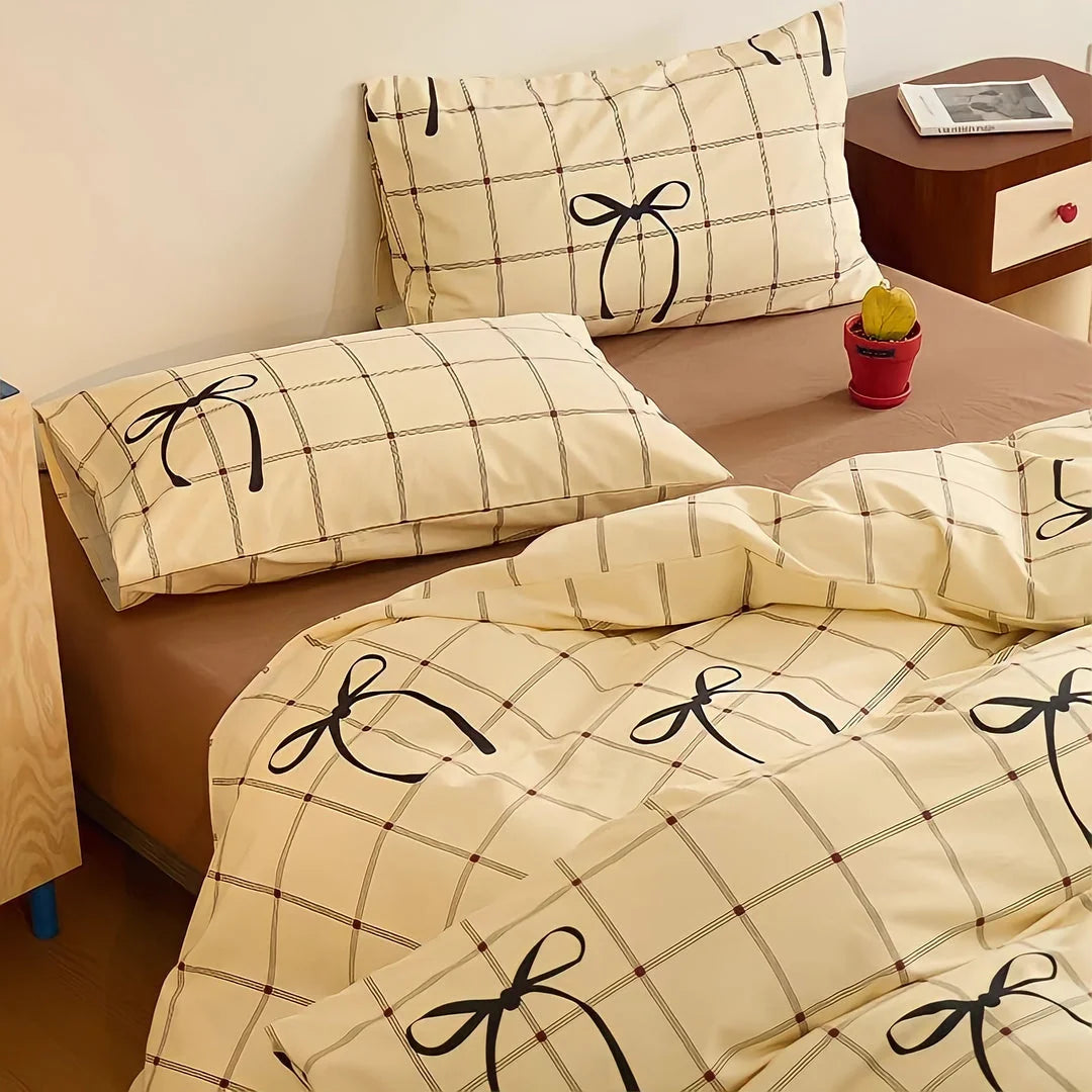 Soft Bow & Plaid Cotton Bedding Set on a bed with a wooden nightstand. - RoomDen