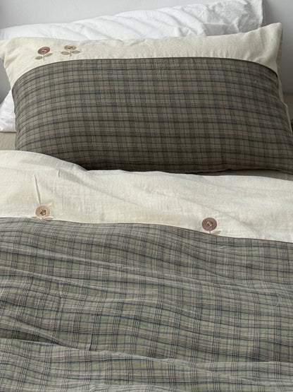 Top-down view of the embroidered floral plaid duvet cover and matching pillowcases. - RoomDen