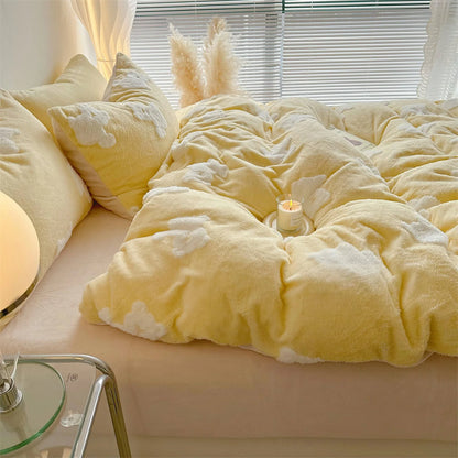Close-up of a plush yellow flannel fleece bedding set with white teddy bear patterns, with a lit candle on the duvet. - RoomDen