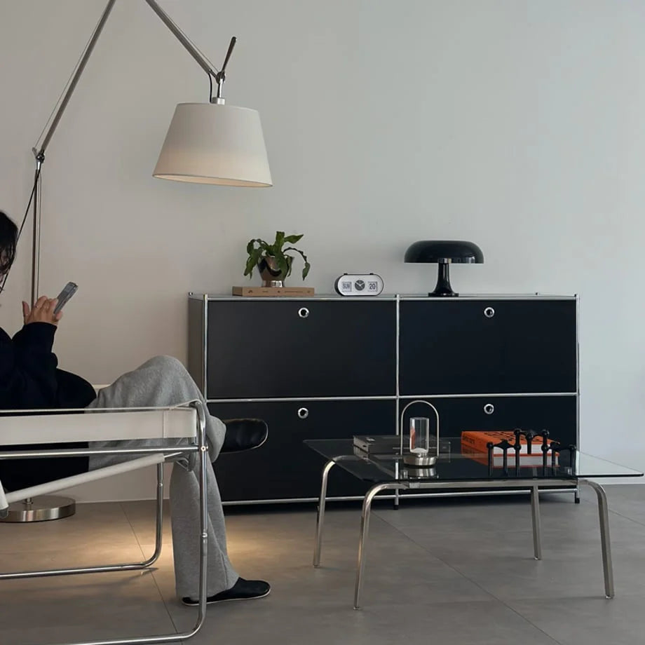 Lifestyle scene showing the Minimalist Arch Metal Table Lamp in a modern living room with black cabinets. - RoomDen