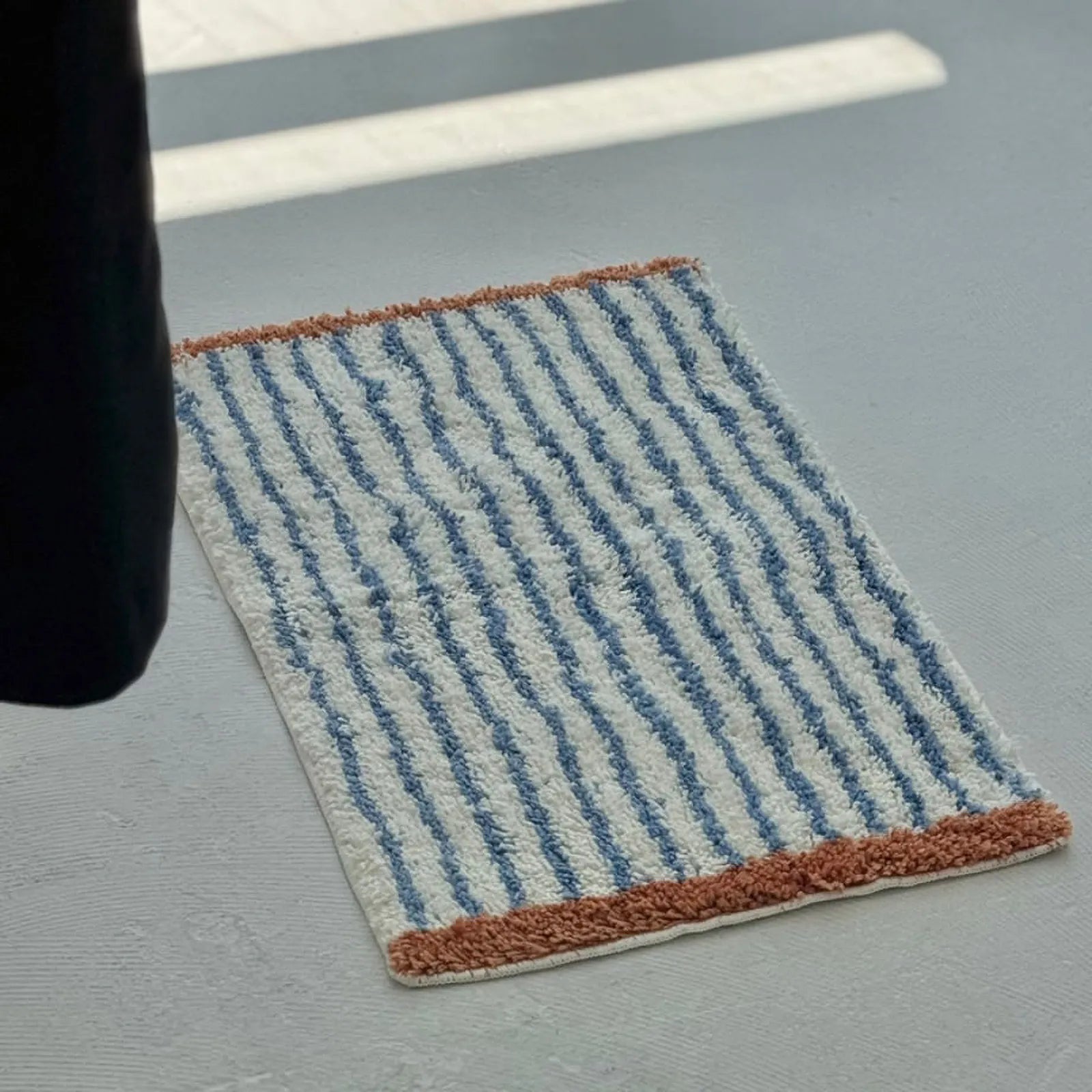 Angled view of Brown & Blue Striped variant showing texture and pile height