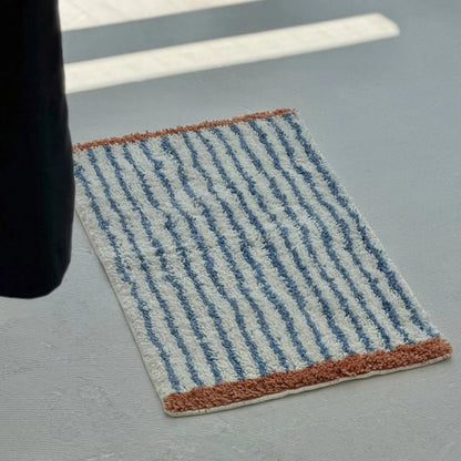 Angled view of Brown & Blue Striped variant showing texture and pile height