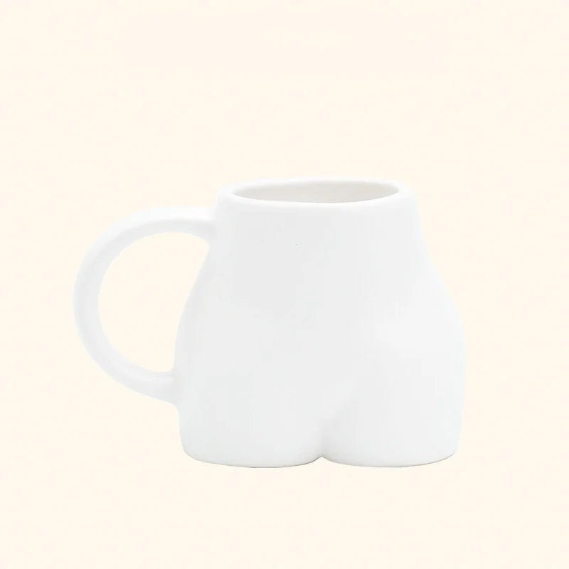 The white sculptural body ceramic mug with a matte finish on a white background. - RoomDen