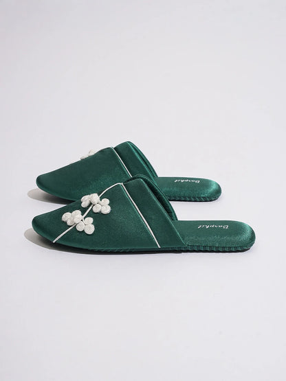 Side view of Green slippers displaying sleek silhouette and flat sole - RoomDen