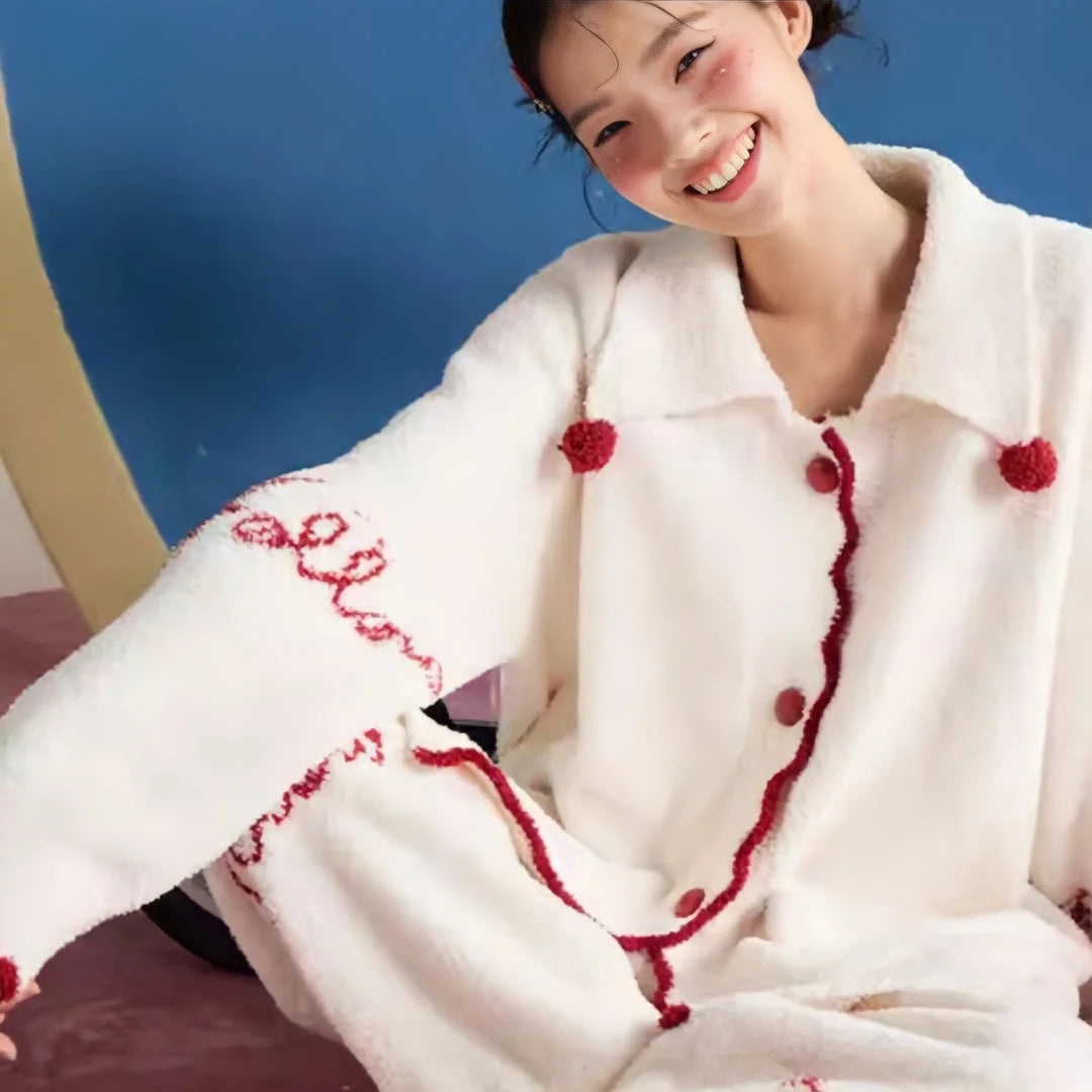 A happy model showcasing the comfort and playful design of the embroidered fleece pajama set.