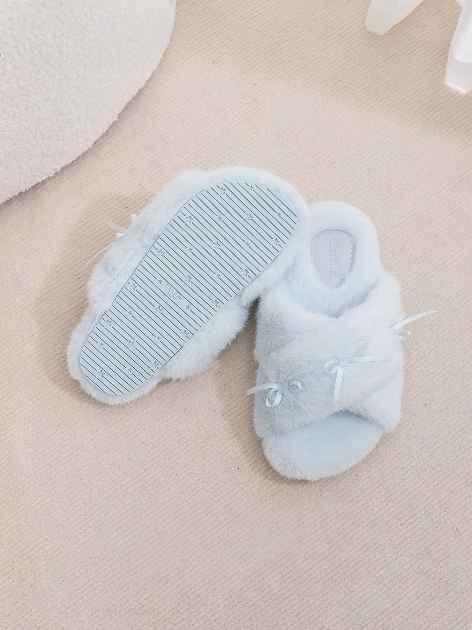Sole view of blue slippers displaying non-slip texture and size - RoomDen