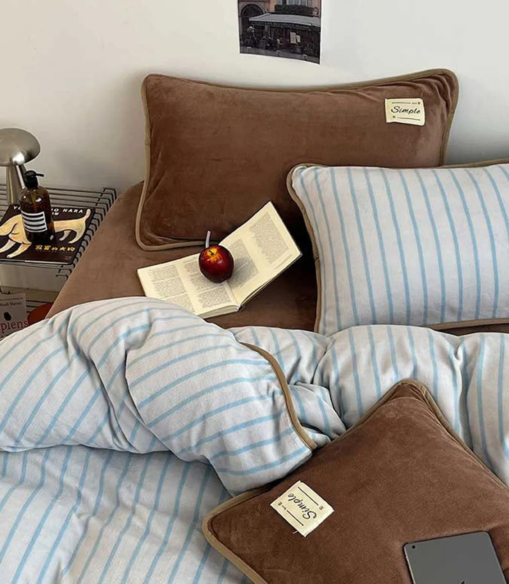Overhead view of the Mocha Brown Striped Flannel Fleece Bedding Set with an open book and apple. - RoomDen