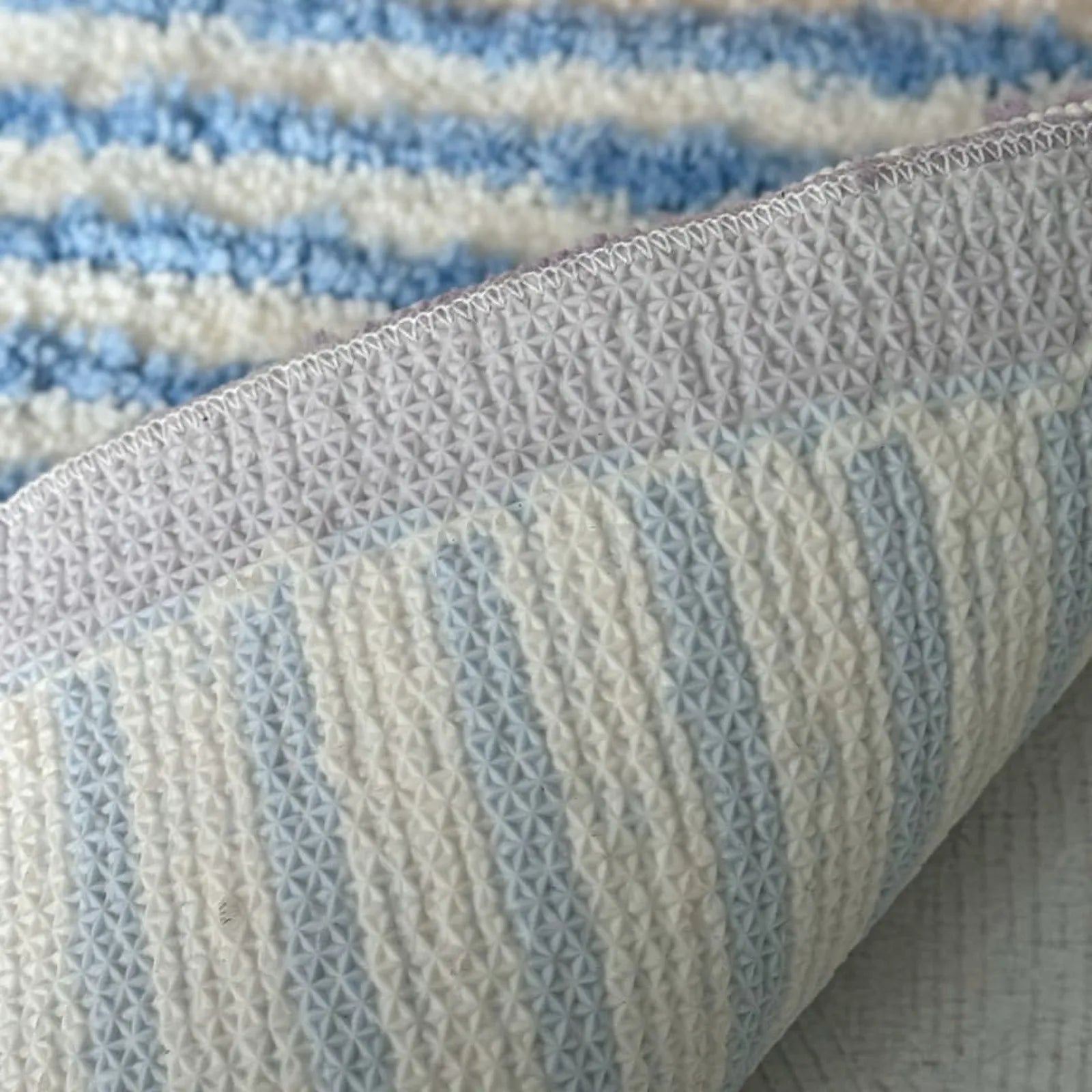 Detail view of non-slip TPR backing on the wavy striped accent rug