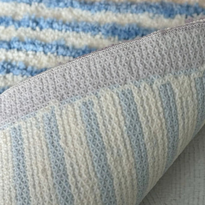 Detail view of non-slip TPR backing on the wavy striped accent rug