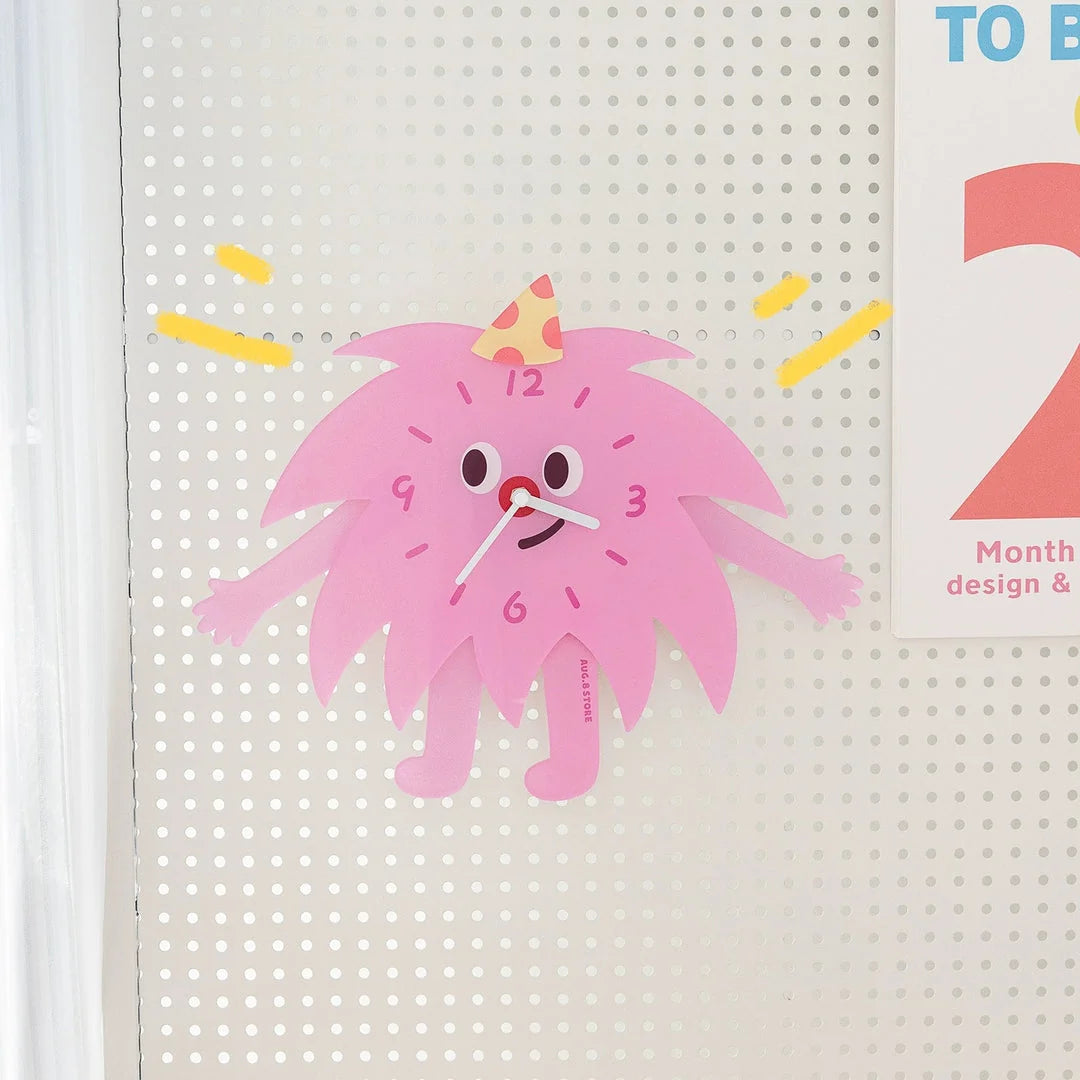 Whimsical Party Monster Acrylic Clock in pink on a white pegboard wall - RoomDen.