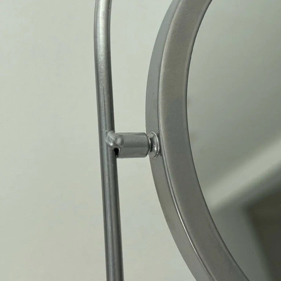 Detailed close-up of the swivel mechanism on the metal mirror frame. - RoomDen