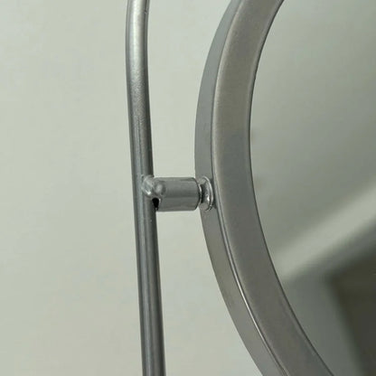 Detailed close-up of the swivel mechanism on the metal mirror frame. - RoomDen