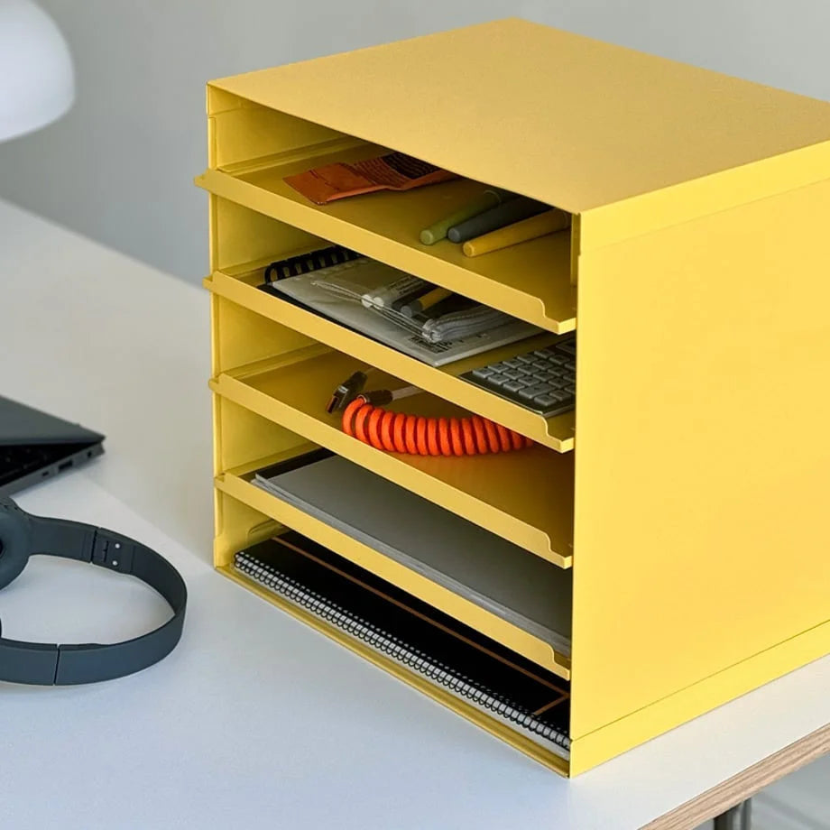 Angled close-up of the Sunny Yellow organizer's shelves holding notebooks and pens - RoomDen.