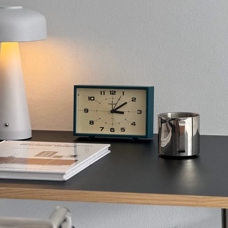 The Forest Green Retro Table Clock adding a pop of color to a minimalist workspace.