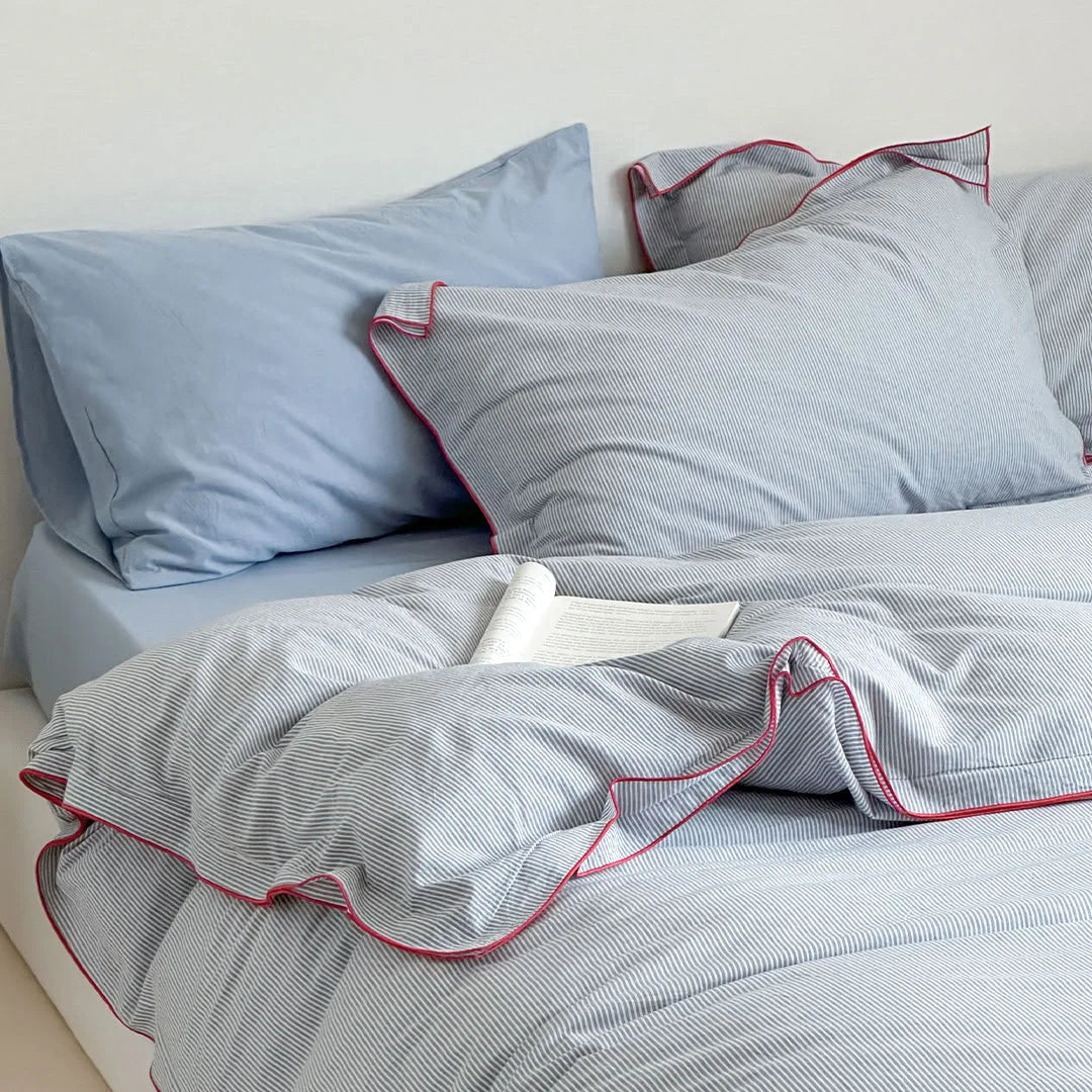 Close-up of the pillows from the Light Grey & Red Pinstripe Washed Cotton Bedding Set.