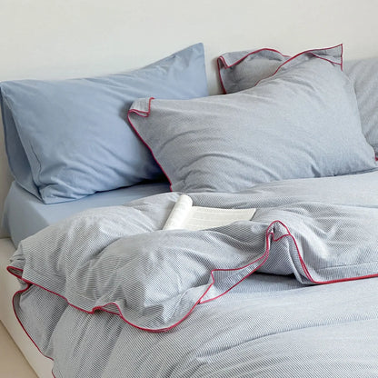 Close-up of the pillows from the Light Grey & Red Pinstripe Washed Cotton Bedding Set.