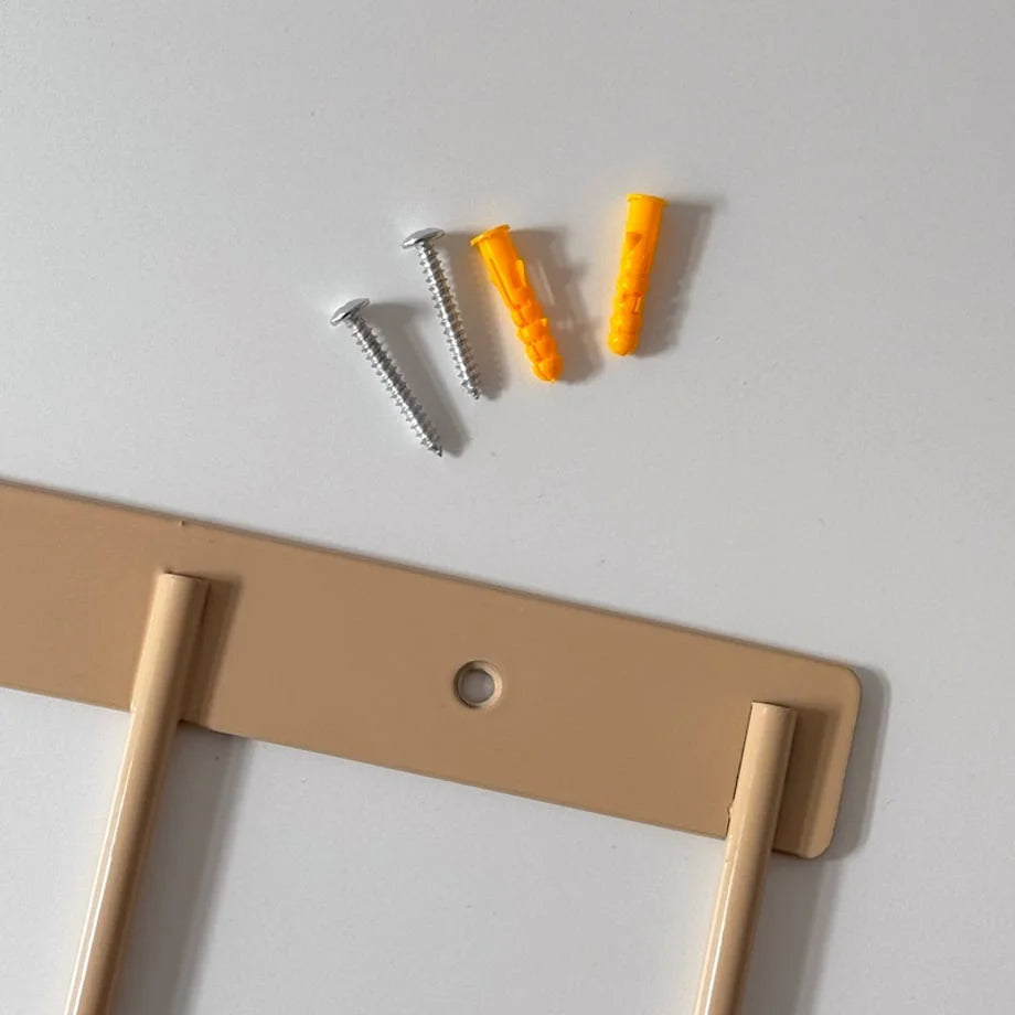 Close-up of the installation hardware, including screws and anchors, for the metal wall hooks. - RoomDen
