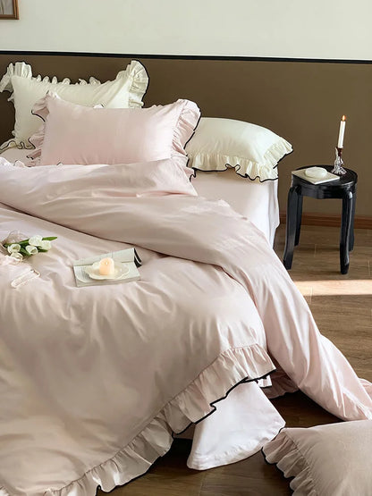 Angled view of the Blush Pink ruffled Tencel bedding, showcasing its drape and silky sheen in natural light - RoomDen.