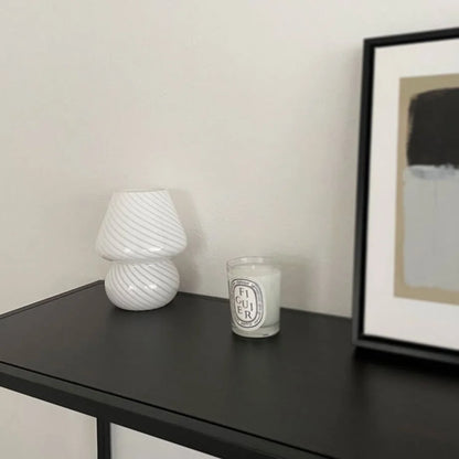 The Swirled Glass Mushroom Lamp unlit, showing its white swirl pattern on a dark surface.