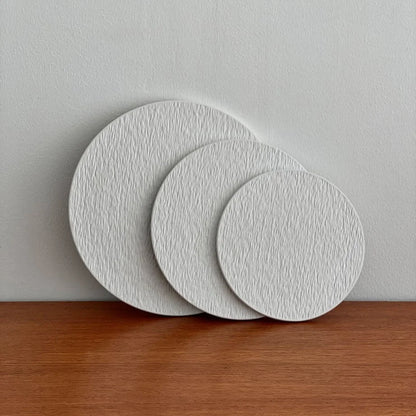 The three textured ceramic trays standing upright and overlapping to showcase their profile and surface detail. - RoomDen