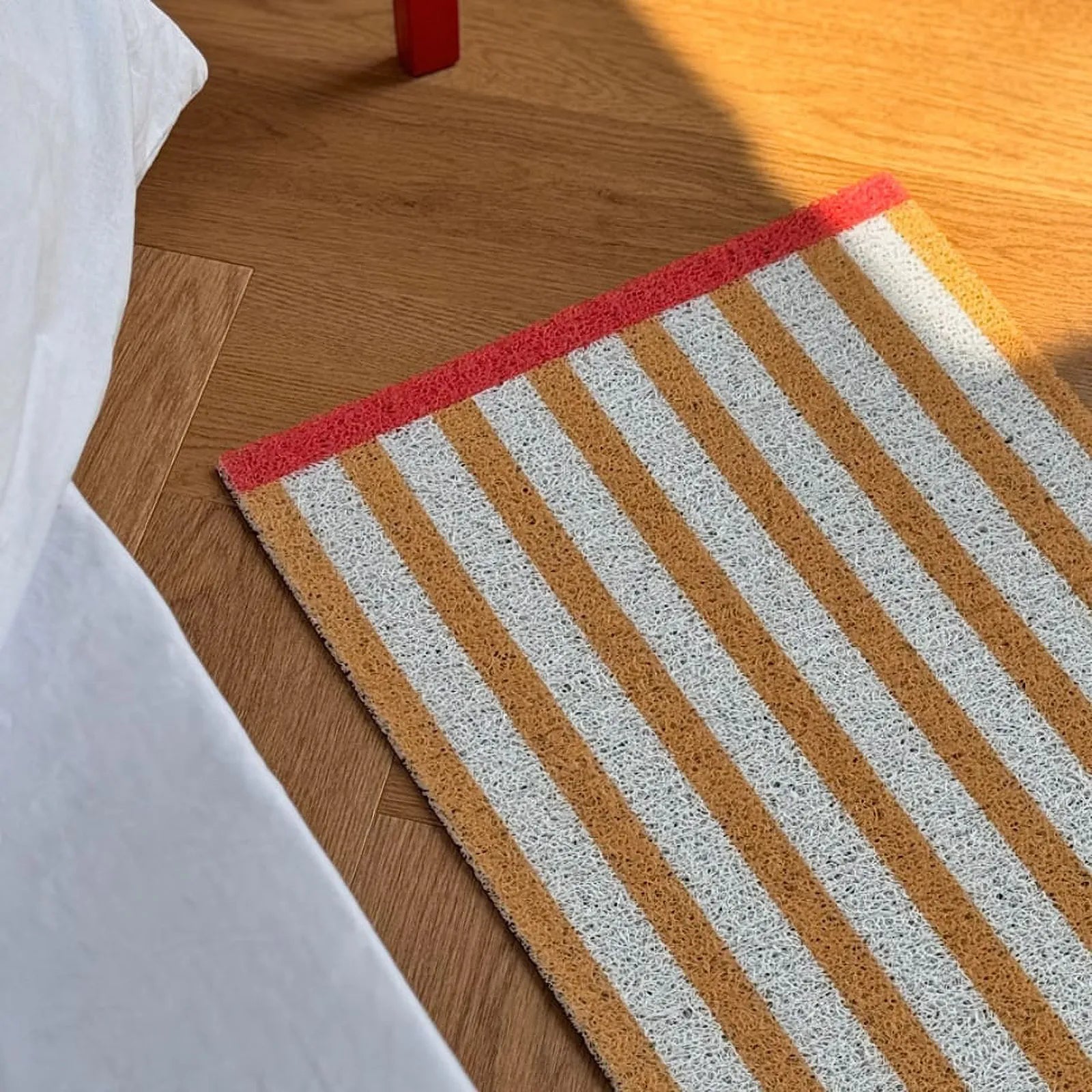 Mustard Yellow Striped PVC Coil Rug main view with red border - RoomDen
