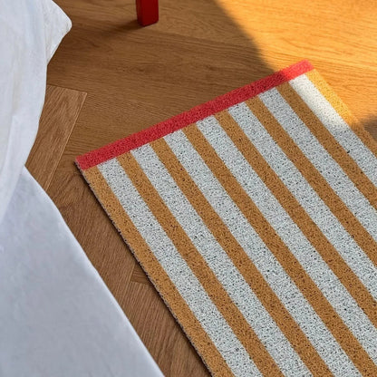 Mustard Yellow Striped PVC Coil Rug main view with red border - RoomDen
