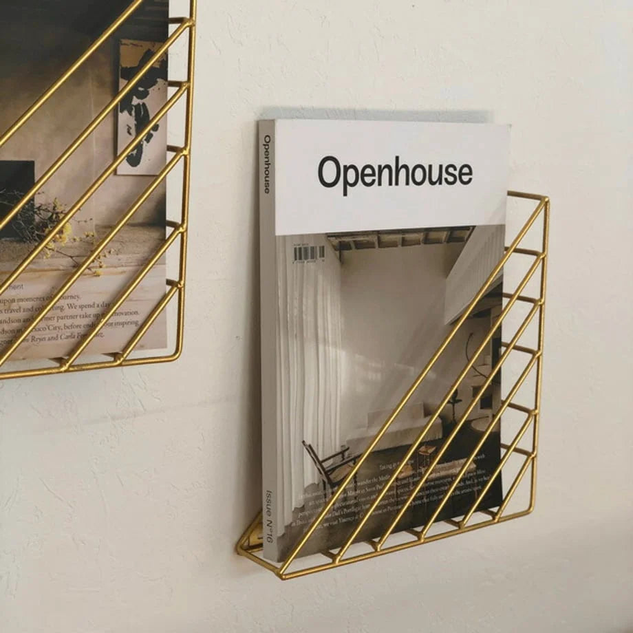 Angled view of the triangular metal magazine rack, showcasing its slim profile - RoomDen