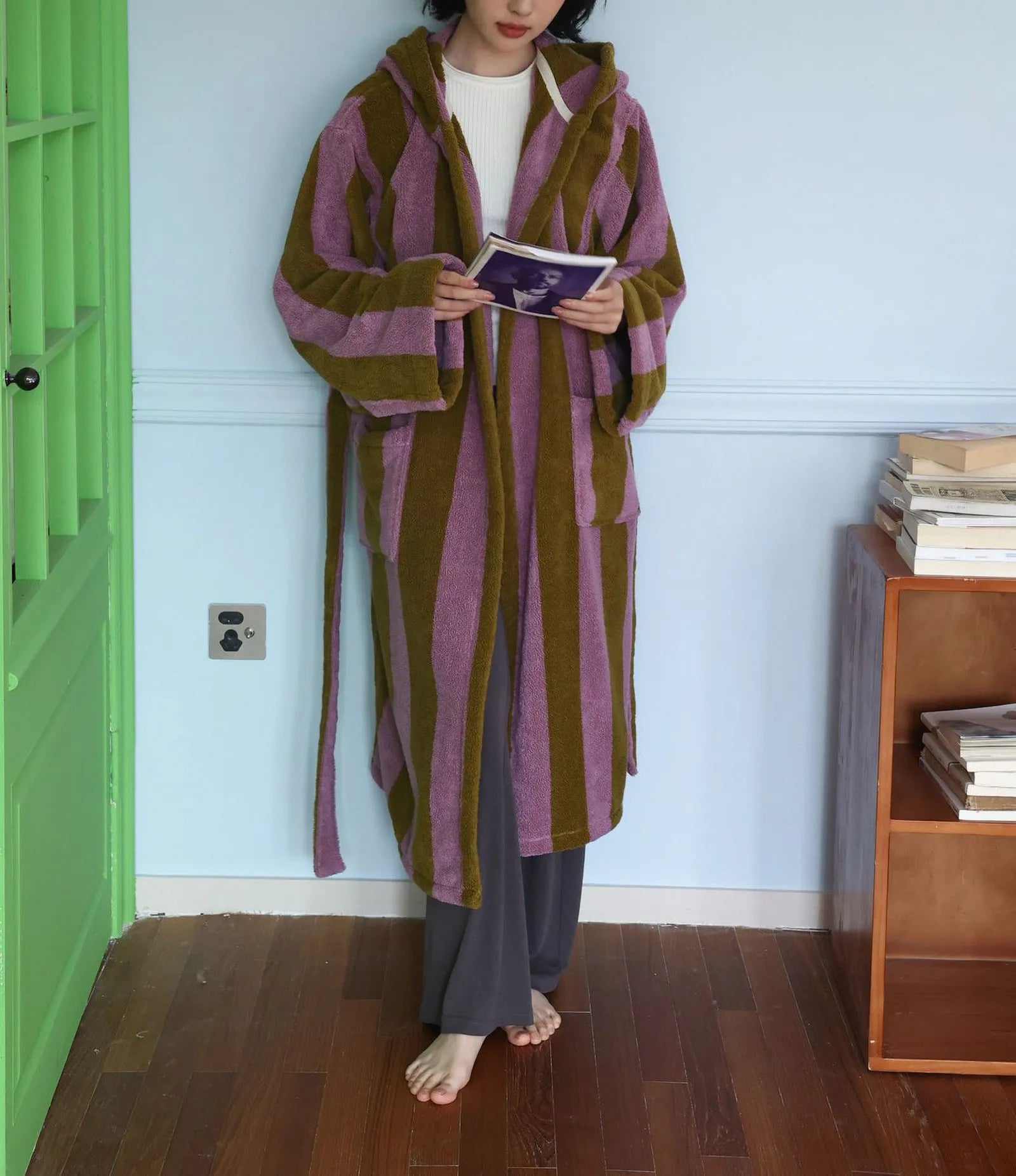 Full length view of a plush cotton bathrobe with wide vertical stripes in green and purple.