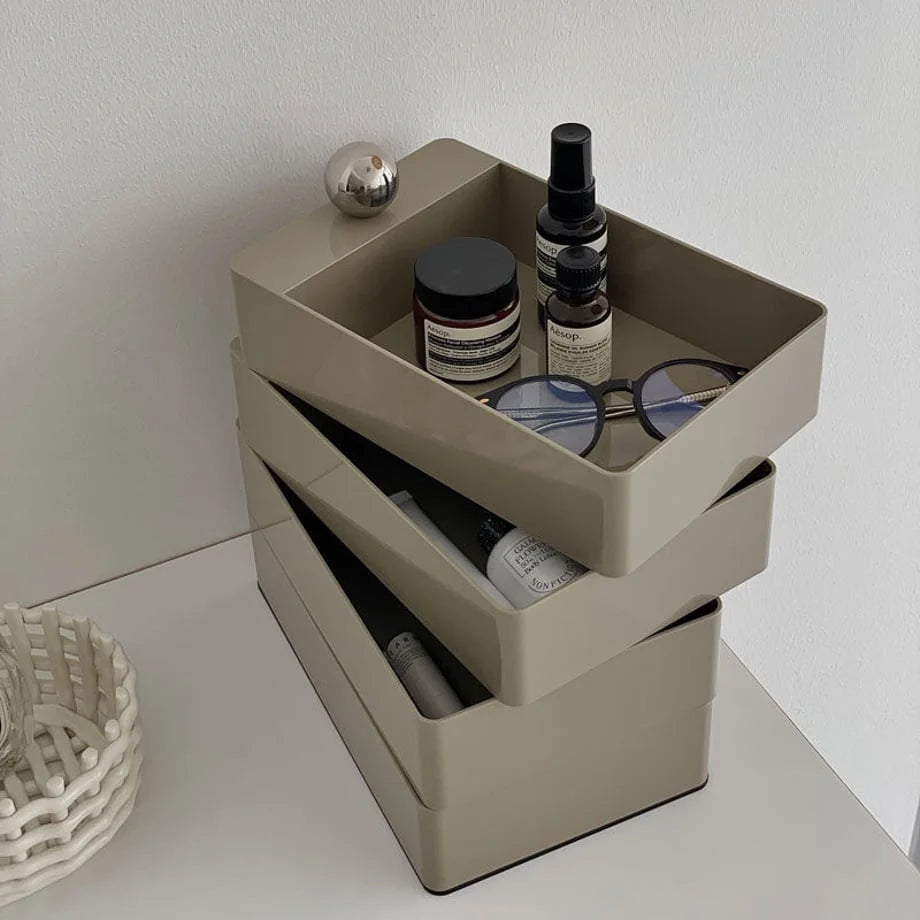 The Khaki Grey makeup organizer swiveled open, revealing multiple tiers for storage.
