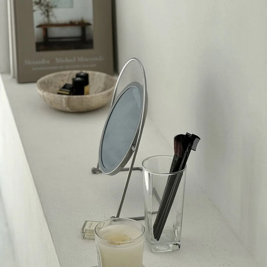 Angled view of the industrial-style metal tabletop mirror, showing its slim profile. - RoomDen