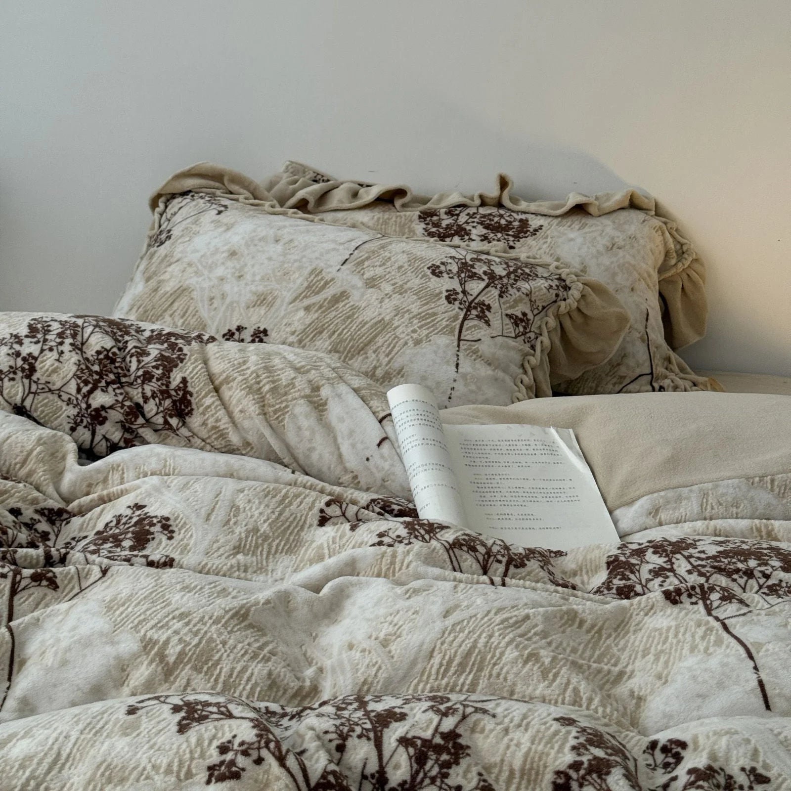 Angled view of the bed dressed in the floral branch washed cotton bedding set, emphasizing its soft, inviting ruffles and cozy aesthetic - RoomDen.