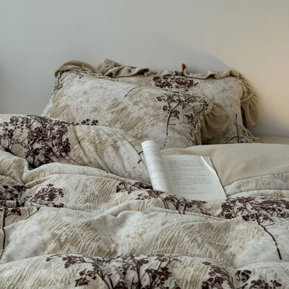 Angled view of the bed dressed in the floral branch washed cotton bedding set, emphasizing its soft, inviting ruffles and cozy aesthetic - RoomDen.