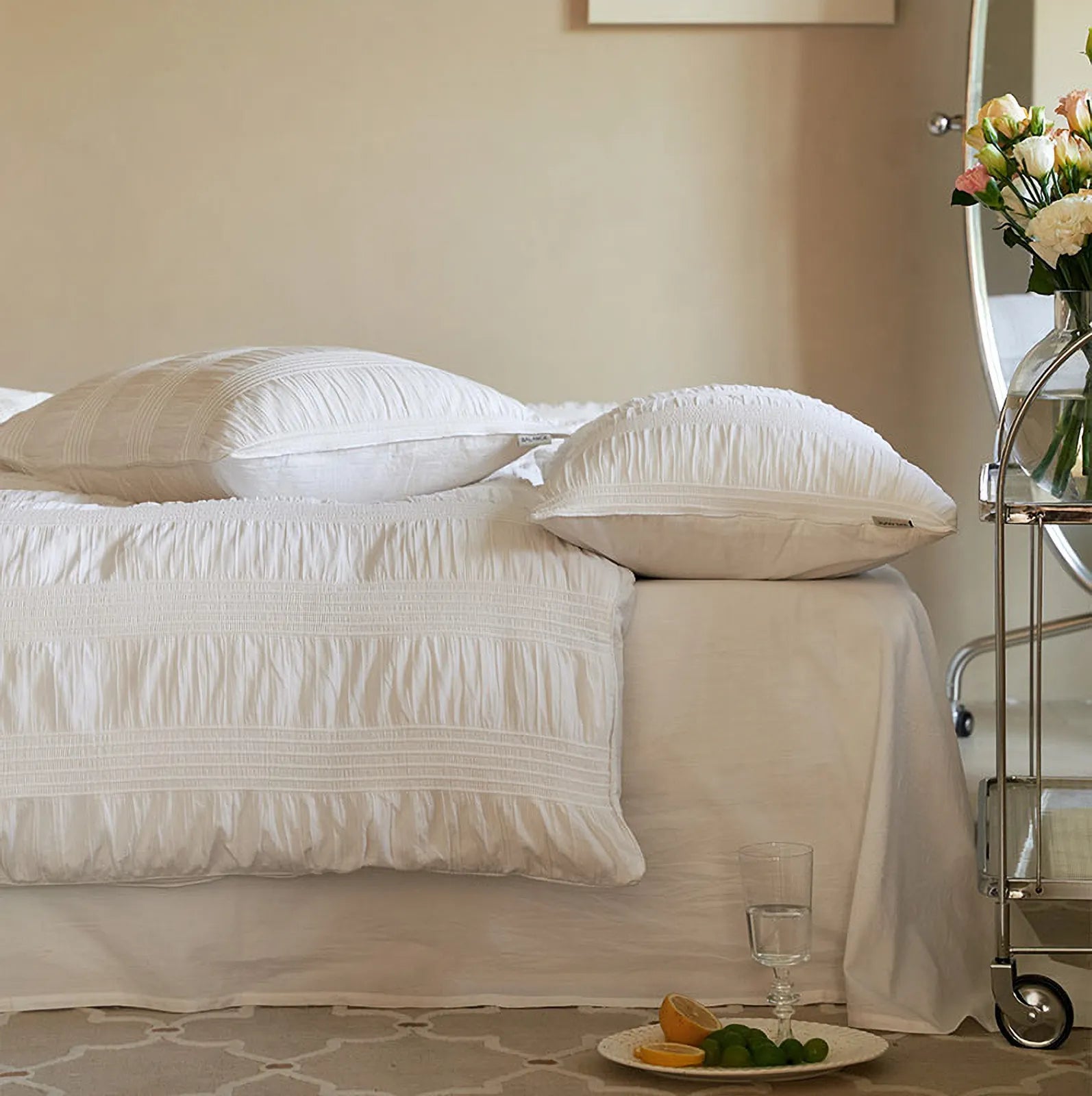 Side view of the Classic White pintuck bedding, showing the pillowcases and duvet cover edge.