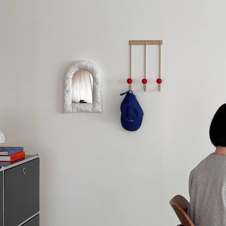 Wide lifestyle shot showing the Beige & Red wall hooks as a piece of functional decor in a modern room. - RoomDen