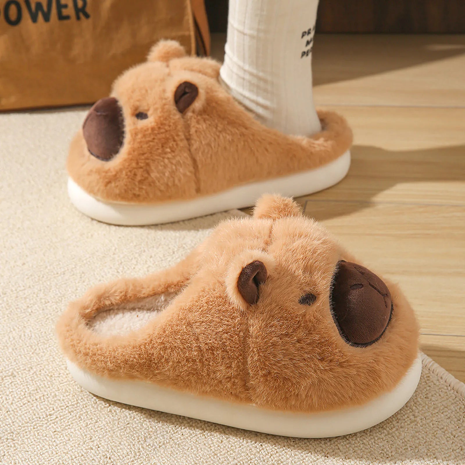 Side view of Cocoa Brown Capybara fuzzy slippers on floor RoomDen