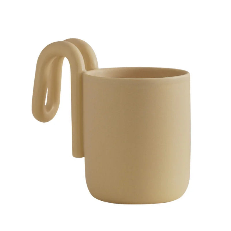 Cream frosted ceramic mug with sculptural loop handle, alternate angle - RoomDen