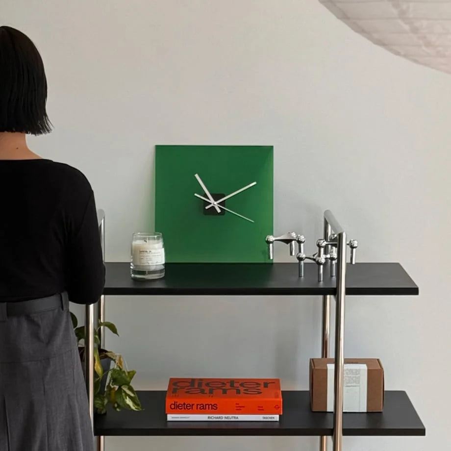 Sleek Solid Color Acrylic Table Clock in Emerald Green on a black and chrome shelf. - RoomDen