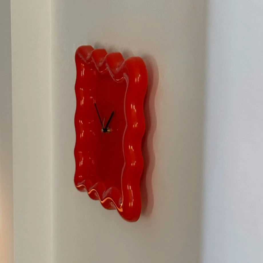 Side profile of the glossy red Wavy Squiggle Clock, emphasizing its unique, fluid shape. - RoomDen