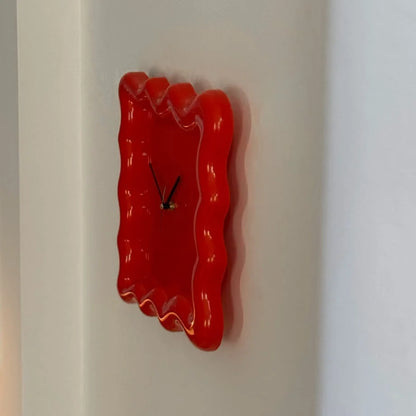 Side profile of the glossy red Wavy Squiggle Clock, emphasizing its unique, fluid shape. - RoomDen