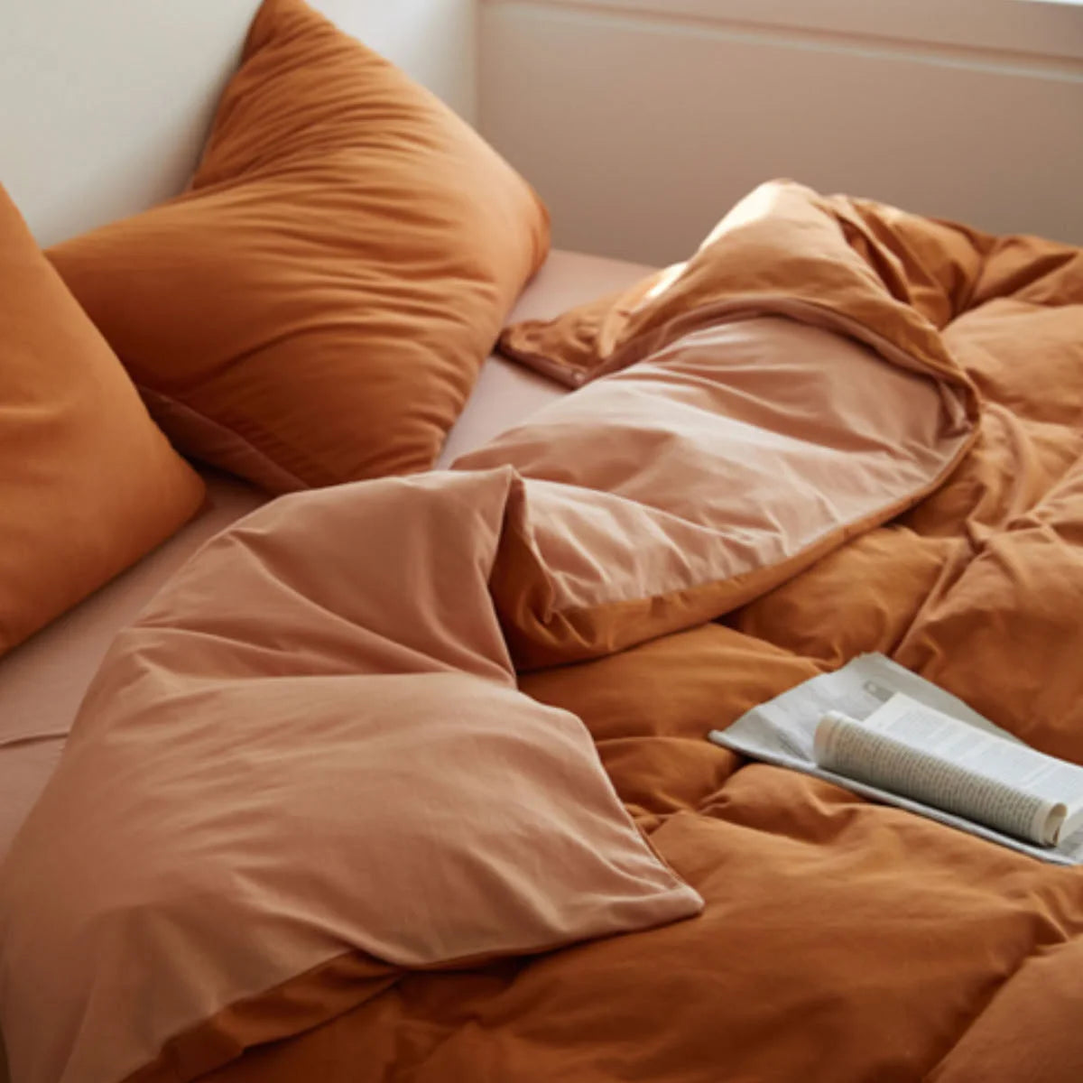 Detail of Reversible Duvet Fold showing Terracotta and Peach Colors - RoomDen