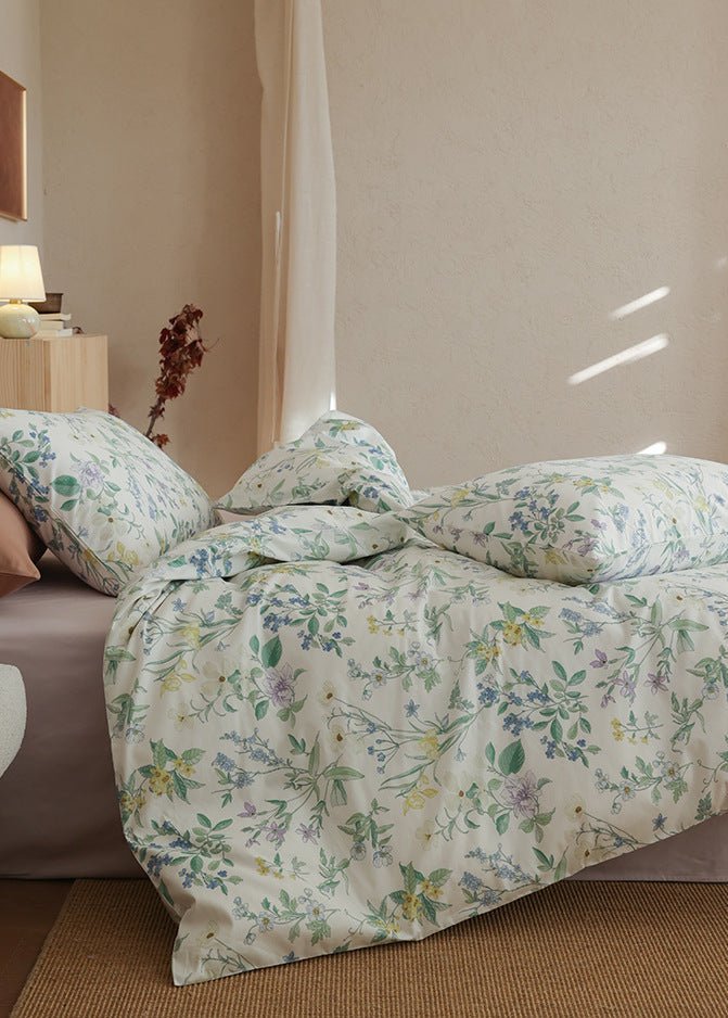 Verbena Botanical Cotton Bedding Set – side view of the draped wildflower duvet beside a nightstand - Roomden