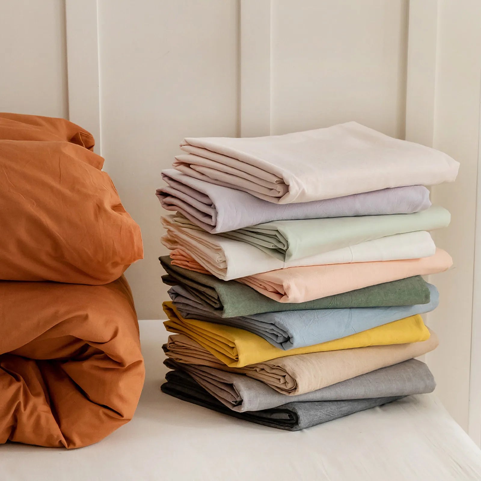 Soft pastel solid washed cotton duvet cover and pillowcases in a cozy minimalist bedroom – RoomDen