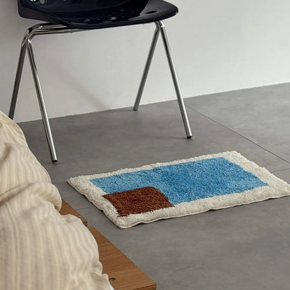 Side angle view of Modern Color Block Plush Accent Rug on the floor emphasizing the soft texture and color contrast - RoomDen