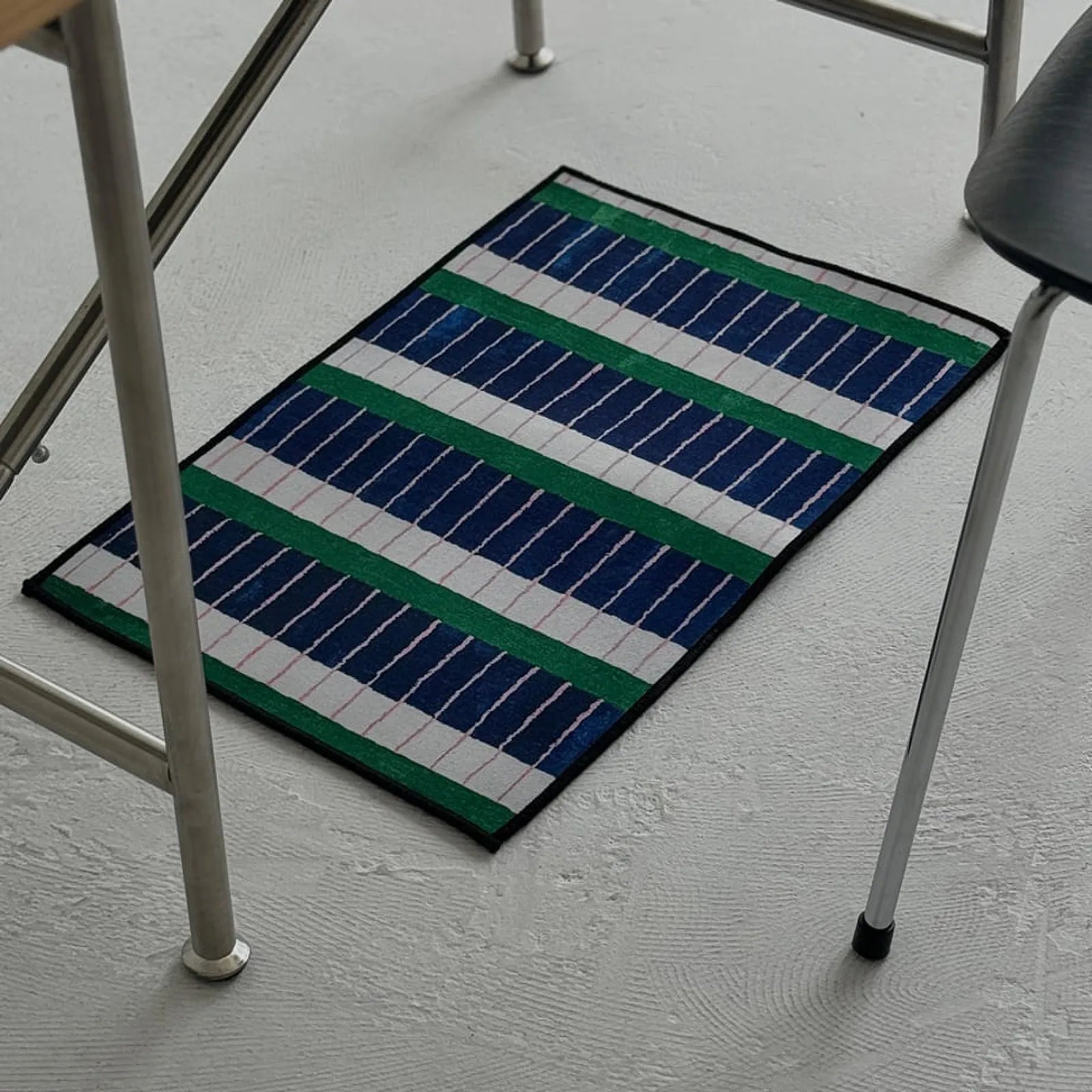 Top-down full view of the RoomDen geometric rug showing the repeating blue, white, and green stripe pattern.