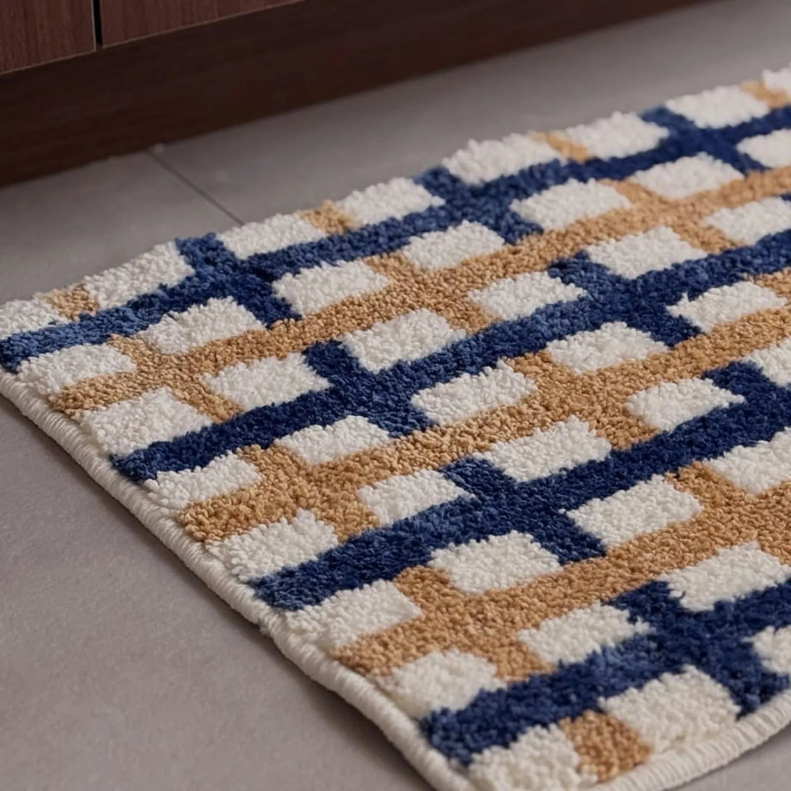 Close-up texture shot showing the tufted cream, blue, and tan fibers - RoomDen