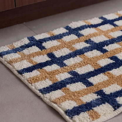 Close-up texture shot showing the tufted cream, blue, and tan fibers - RoomDen