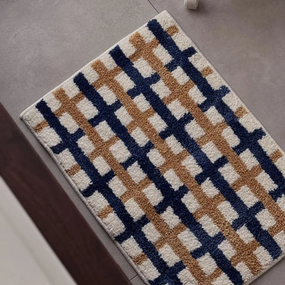 Full flat lay view of the rectangular plaid accent rug on grey tile - RoomDen