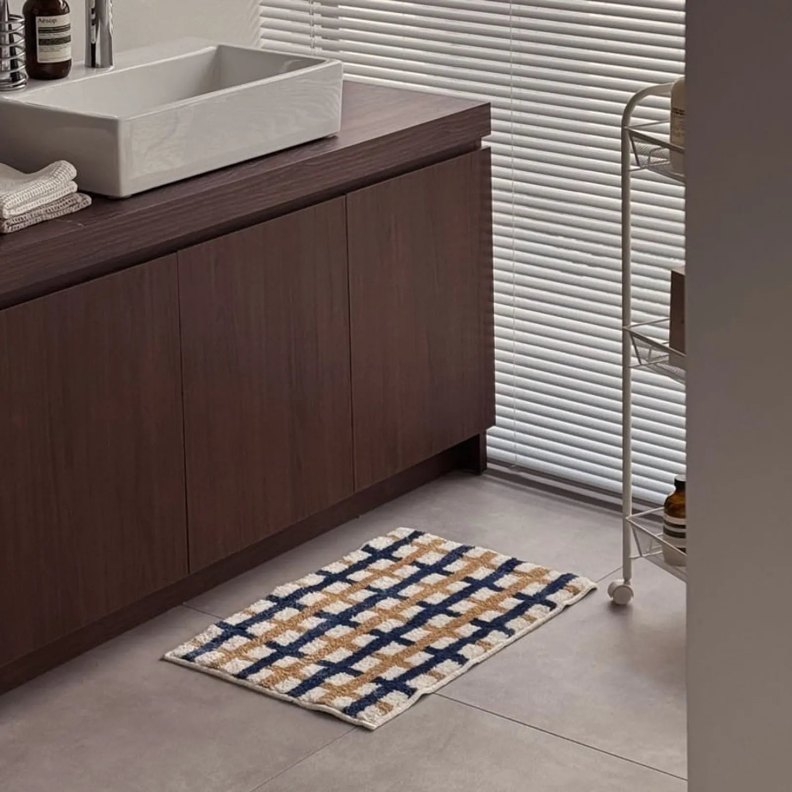 Bathroom scene showing the rug placed in front of a modern sink vanity - RoomDen